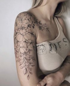 a woman with a flower tattoo on her arm