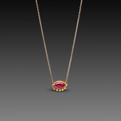 A vibrant rose cut ruby is wrapped in warm 22k gold, and accented with a delicate arc of five twinkling diamonds. Backed in 18k gold, and set on a 14k gold chain. Pendant measures approximately 7/16 inch across. Matte finish. Fine Jewelry Ruby Oval Pendant Necklace, Yellow Gold Ruby Oval Pendant Necklace, Ruby Pendant In Yellow Gold, Ruby Necklace With Polished Yellow Gold Finish, Ruby Pendant With Diamond Cut, Ruby Necklace, 22k Gold, Rose Cut, Chain Lengths