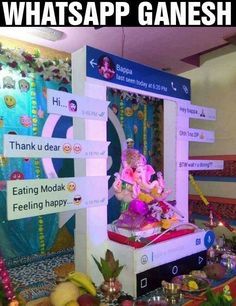 there is a ganesh idol on display in the middle of a room with many signs