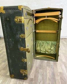 an open suitcase sitting on top of a hard wood floor next to a white wall