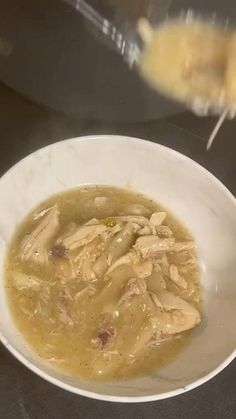 a white bowl filled with soup on top of a table