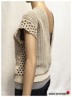 a mannequin wearing a white crochet top