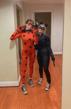 two women in costumes posing for a photo