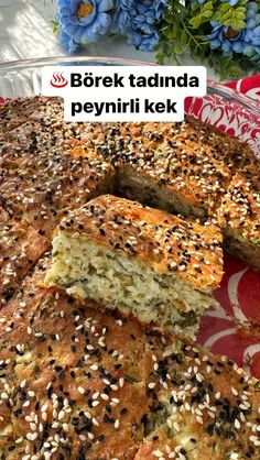 a close up of a cake on a plate with sesame seed toppings and the words bork taduna peyirii kek above it