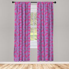 a purple curtain with pink flowers on it in front of a gray wall and wooden floor