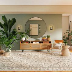 a living room filled with furniture and potted plants in front of a round mirror