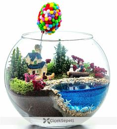 a fish bowl filled with water and lots of colorful balls floating in it's air