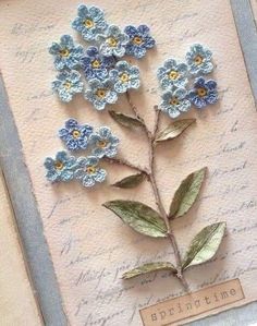 a card with blue flowers and leaves on it