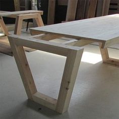 a table made out of wood sitting on top of a white floor