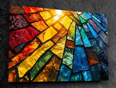 a multicolored stained glass window on the wall