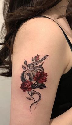 a woman with a snake and roses tattoo on her arm