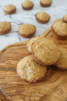 some muffins sitting on top of a wooden plate