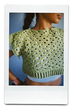 a woman wearing a green crocheted top