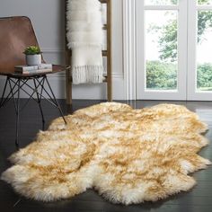 a living room with a chair and rug on the floor