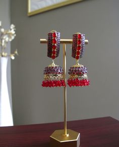 Red & Gold Jhumka Earrings perfect for any Pakistani/Indian wedding event! **All products are handmade and triple checked before shipping to ensure premium quality** Red Bridal Earrings For Festive Wedding, Festive Red Bridal Earrings For Wedding, Red Bridal Earrings For Wedding, Red Drop Earrings Danglers For Wedding, Red Drop Danglers For Wedding, Red Temple Jewelry Bridal Earrings For Wedding, Festive Red Chandbalis With Cutdana, Elegant Red Danglers For Festive Occasions, Elegant Red Danglers For Festive Events