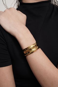 The Allure Cuff is a standout bracelet guaranteed to make a statement. Plated in 18k Gold with a special e-coating for scratch resistance, the Allure Cuff is guaranteed to be a staple in your closet. Luxury Wide Band Cuff Bracelet For Formal Occasions, Luxury Wide Band Bangle, Luxury Gold Open Cuff Bangle, Luxury Gold Wide Band Bangle, Luxury Wide Band Gold Bangle, Luxury Cuff Bracelet With Polished Finish, Luxury Wide Band Cuff Bracelet With Polished Finish, Luxury Polished Wide Band Cuff Bracelet, Luxury Adjustable Wide Band Bangle