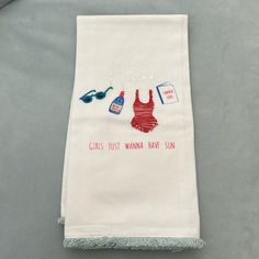 a towel with some clothes hanging from it's side on a table next to a pair of scissors