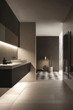 a large bathroom with black and white tile flooring on the walls, along with two sinks