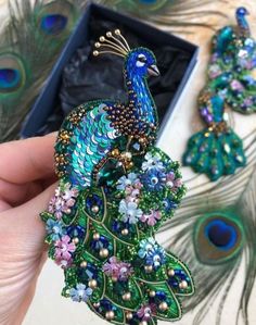 a peacock brooch sitting on top of a table