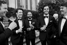 a group of men in tuxedos standing next to each other