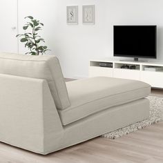 a living room with a gray couch and television