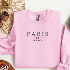 Embrace the charm of Paris with our Minimalistic Paris France Embroidered Crewneck. Perfect for Paris enthusiasts and fashion-forward individuals, this unisex crewneck offers a stylish yet understated way to show your love for the City of Light. Features: Design: Center chest embroidery featuring "Paris France" with a mini French flag accent Material: Soft and durable 50/50 cotton-polyester blend for maximum comfort and longevity Sizes: Available in unisex sizes S, M, L, XL, and 2XL Colors: Choo Paris Sweatshirt, French Flag, Visit Paris, Embroidered Crewneck, Pink Sports, Design Center, 50 50, Minimalist Fashion, Paris France