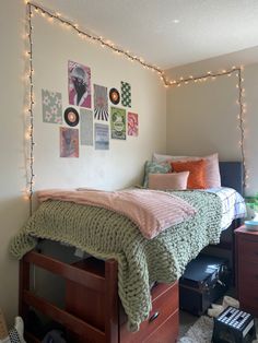 a bedroom with string lights and pictures on the wall