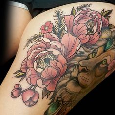 a woman's thigh with flowers and a cat on it