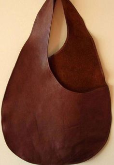 a brown leather purse hanging on the wall