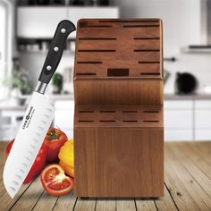 a kitchen knife holder on a wooden table with tomatoes and peppers in front of it