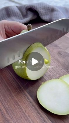 someone is cutting an apple with a knife