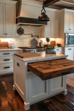 a kitchen with an island in the middle of it and lots of wood flooring