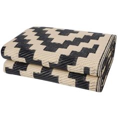 two black and white woven blankets on top of each other, one is folded over the other