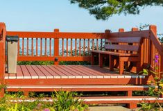 a wooden bench sitting on top of a lush green field