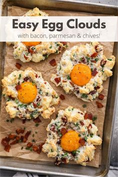 four biscuits with eggs and bacon in them on a baking sheet, ready to go into the oven