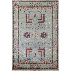 a blue and red rug with an intricate design on the center, surrounded by small flowers