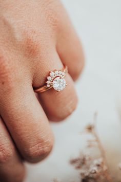 a woman's hand with a diamond ring on it