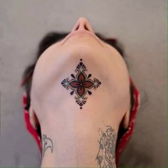 a woman with a cross tattoo on her back