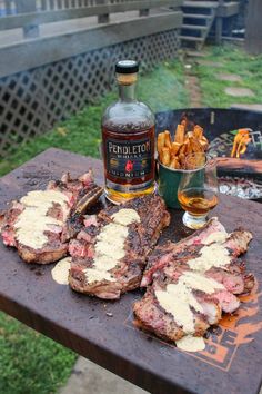 steaks and chips are sitting on a picnic table