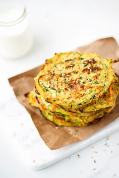 two stacks of zucchini and carrot pancakes on a plate