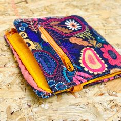 Handcrafted Small Fabric Wallet with Vibrant Ethnic Print - 10 x 10 cm / 4 x 4 inch - 8 card slots - 2 zippered sections for cash and coins Add a touch of unique, artisan-crafted beauty to your everyday essentials with our hand-designed small fabric wallet. Perfectly compact yet spacious enough to hold your cards, cash, and coins, this wallet is a fusion of practicality and vibrant artistry.  Each wallet is meticulously crafted from high-quality fabric, ensuring durability and long-lasting charm Bohemian Multicolor Coin Purse For Daily Use, Handmade Multicolor Coin Purse For Travel, Handmade Multicolor Coin Purse For Everyday Use, Handmade Multicolor Pouch Wallet, Bohemian Handmade Multicolor Coin Purse, Handmade Multicolor Coin Purse, Bohemian Multicolor Handmade Coin Purse, Handmade Multicolor Bohemian Coin Purse, Bohemian Handmade Coin Purse For Travel