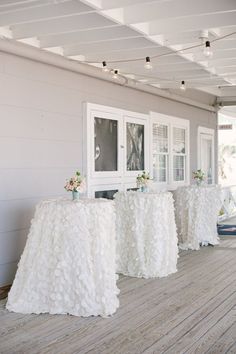 the tables are covered with white ruffled cloths