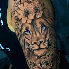 a woman's arm with a lion and flowers tattoo on her left arm, which has blue eyes