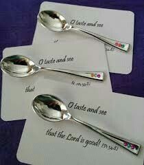 three silver spoons sitting next to each other on top of white cards with words written on them