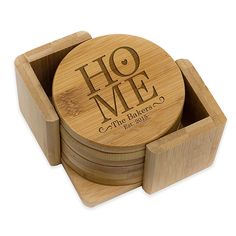 four coasters with the words ho me on them in wooden boxes, stacked next to each other