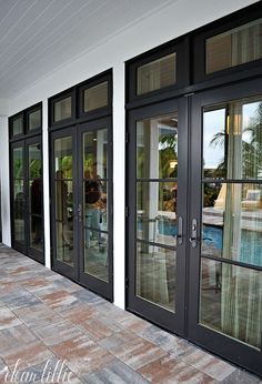 the front entrance to a house with glass doors and sliding glass doors on both sides