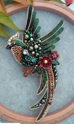 a bird brooch sitting on top of a table