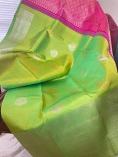 Traditional Kili pachchai (Parrot green) and rani pink turning border kanjeevaram silk saree. The body is a beautiful dual tone of parrot green with alternating motifs of silver and gold zari butta. Turning border is a unique technique of weaving where the border design is enhanced and looks so beautiful .Comes with a contrast Rani pink pallu and an unstitched  blouse. Saree width : 49 inches Maintenance: Dry wash advisable Returns and refund only accepted on defective products. Product should b Green Tilla Dupatta For Puja, Green Raw Silk Traditional Wear For Puja, Green Art Silk Traditional Wear With Tilla Detail, Green Paithani Silk Saree For Festivals, Green Art Silk Traditional Wear With Tilla, Festival Green Paithani Silk Saree, Green Bollywood Saree With Tilla, Multicolor Paithani Silk Saree With Tilla, Multicolor Paithani Silk Saree With Tilla Details