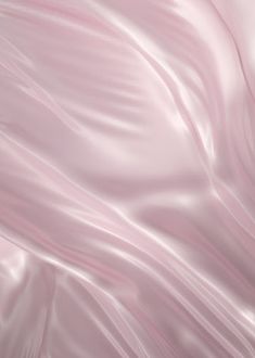 an abstract pink background with smooth lines and folds in the fabric or material that looks like silk