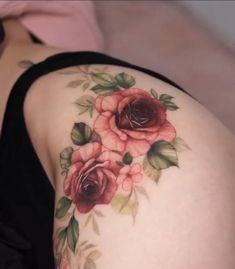 a close up of a woman's thigh with flowers on it